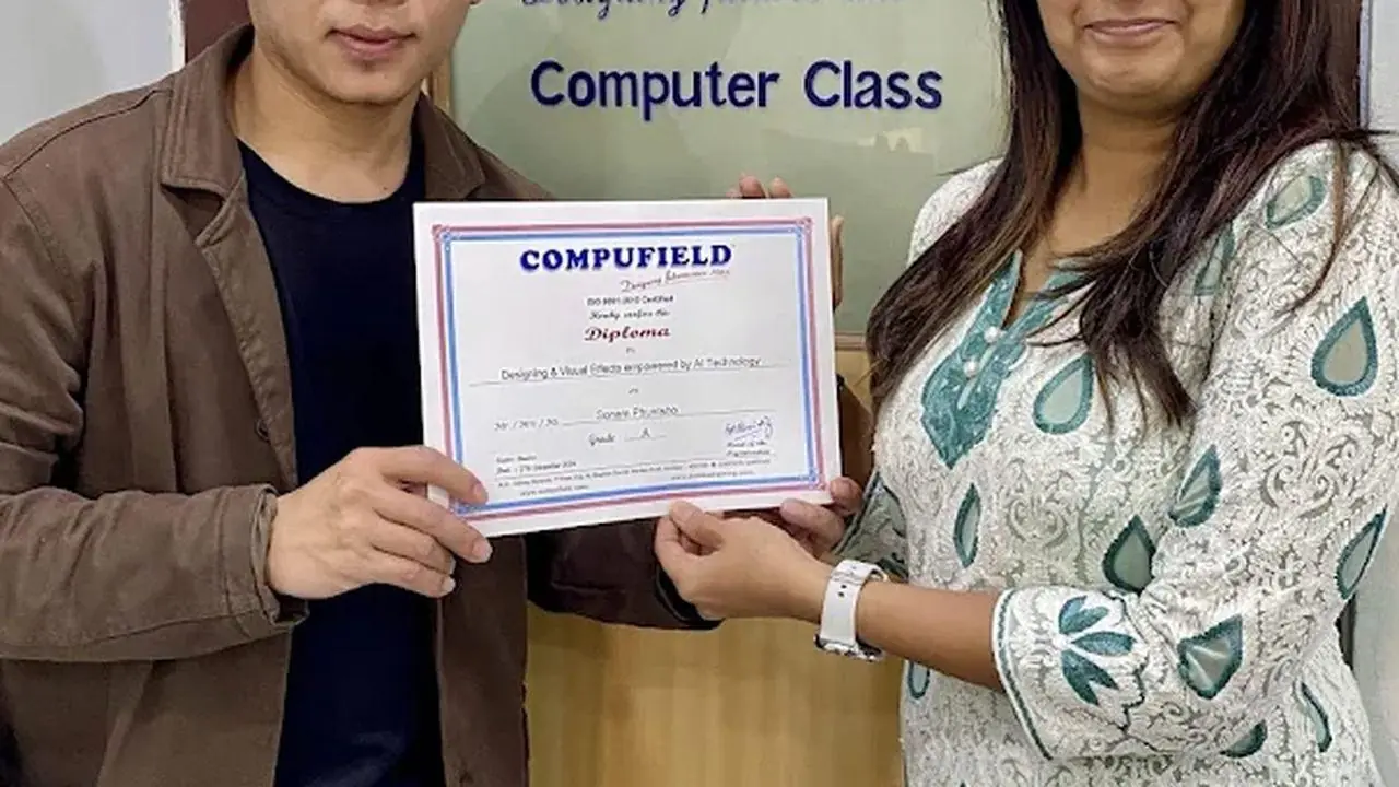 A student receiving a Compufield diploma
